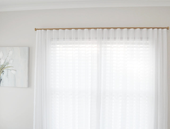 White sheer linen curtains on traverse rod